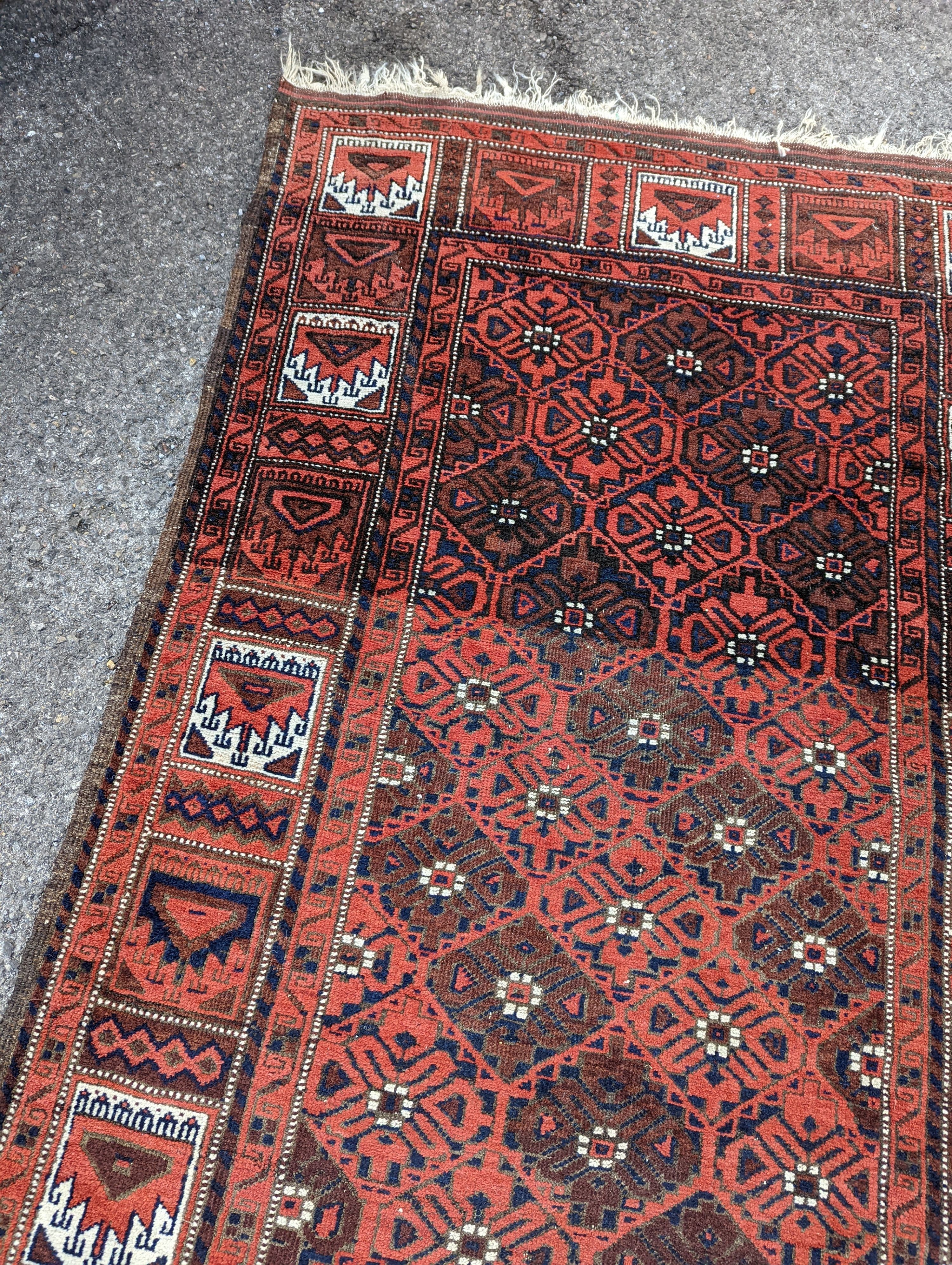 A Turkish red ground rug, 212 x 106cm